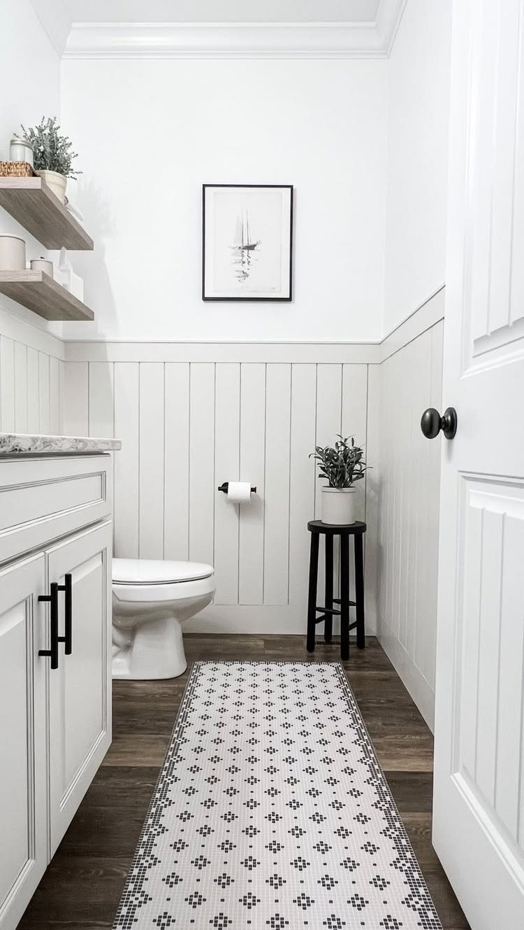 White shiplap wainscoting covers the lower walls of a modern, bright bathroom.