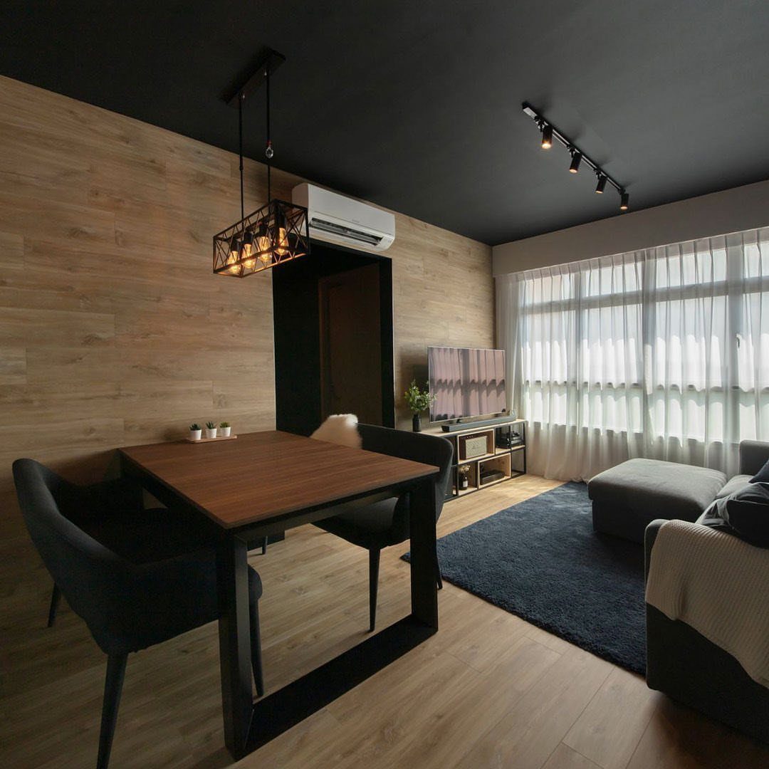 20 Dark Accent Wall Ideas to Try in Any Room 11 A modern room featuring a matte black ceiling, wooden walls, and a dining set.