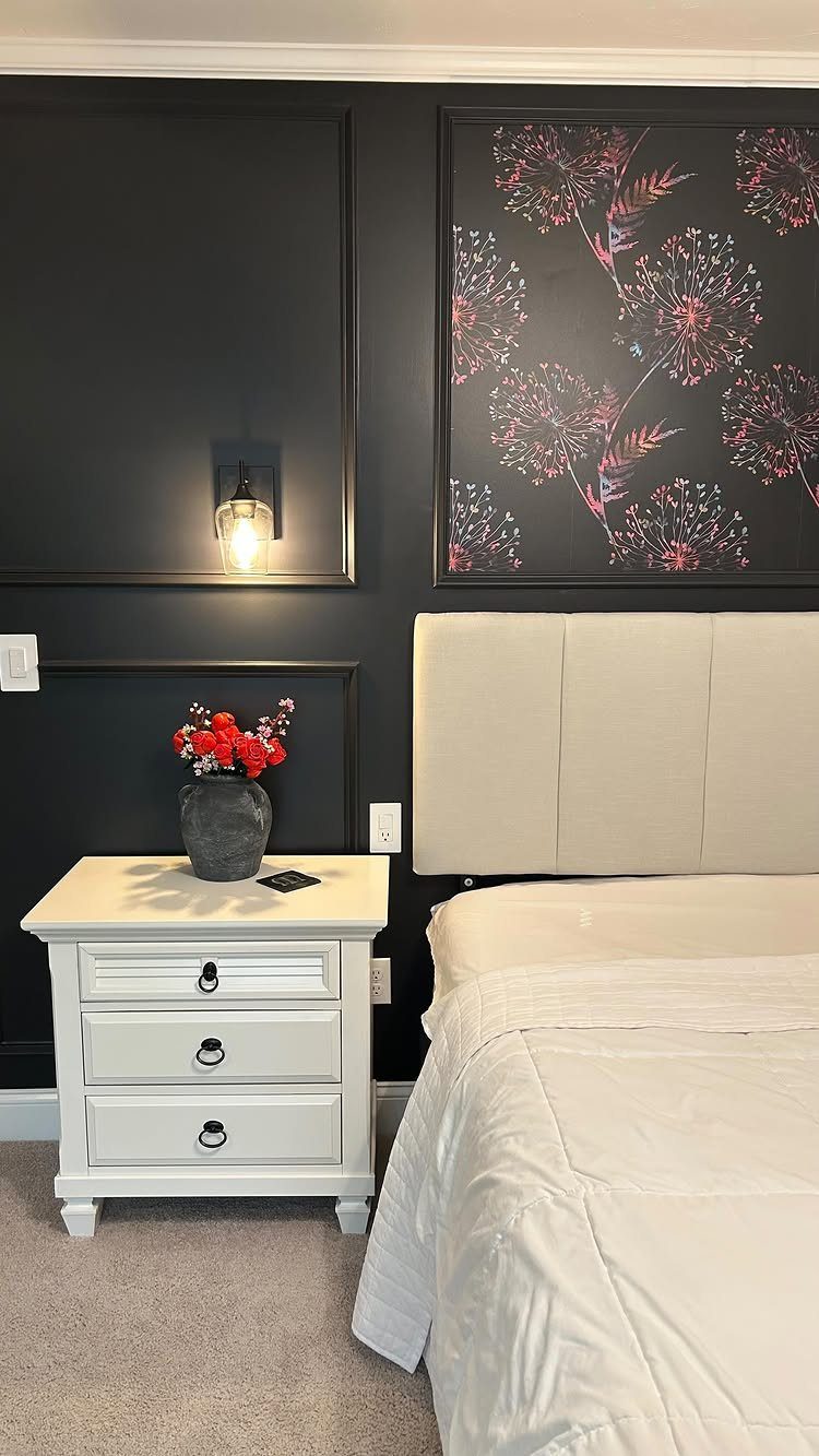 20 Dark Accent Wall Ideas to Try in Any Room 21 Dark floral wallpaper framed on a black accent wall behind a white bed and nightstand.