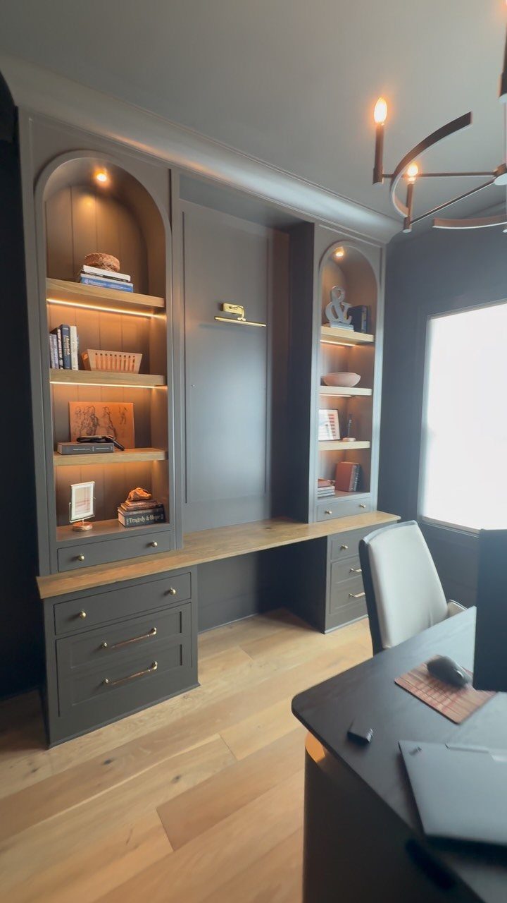 20 Dark Accent Wall Ideas to Try in Any Room 15 Dark gray built-in desk and illuminated shelving unit against a matching dark accent wall.