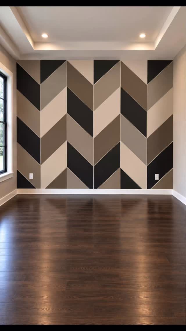 Geometric Accent Wall: 11 Ideas in Wood, Paint, and Light 11 Geometric chevron pattern accent wall in black, tan, and grey tones in an empty room.
