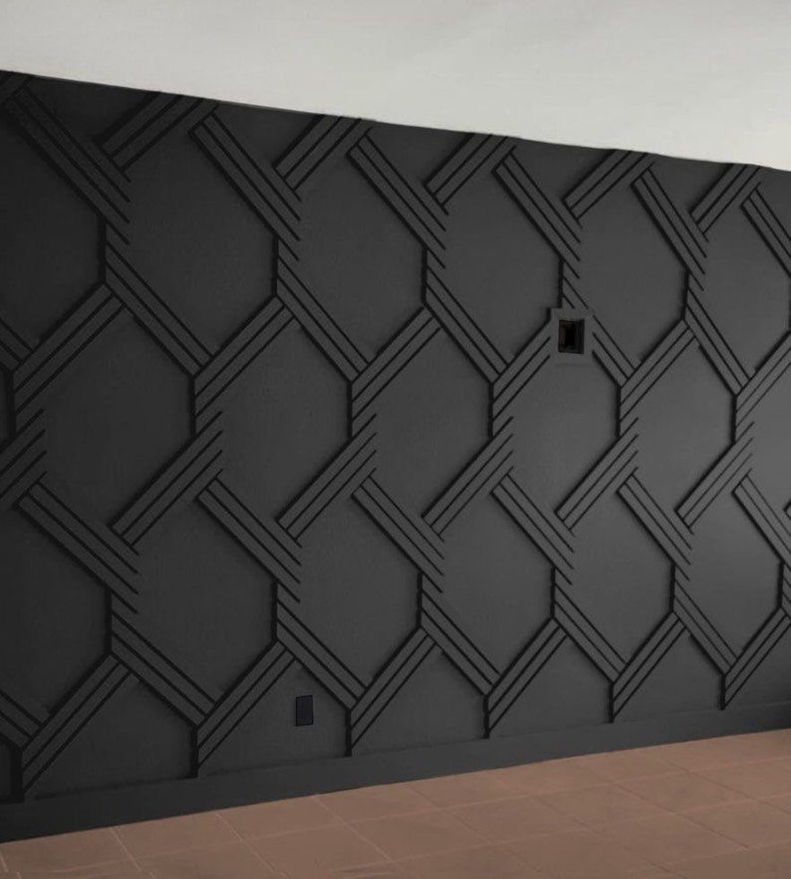 Geometric Accent Wall: 11 Ideas in Wood, Paint, and Light 3 Charcoal grey wall with a raised geometric pattern of interlocking lines and hexagonal shapes.