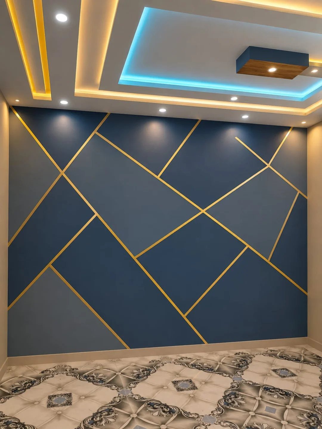 Geometric Accent Wall: 11 Ideas in Wood, Paint, and Light 5 Blue geometric accent wall with gold intersecting lines in a modern room with patterned tiles.