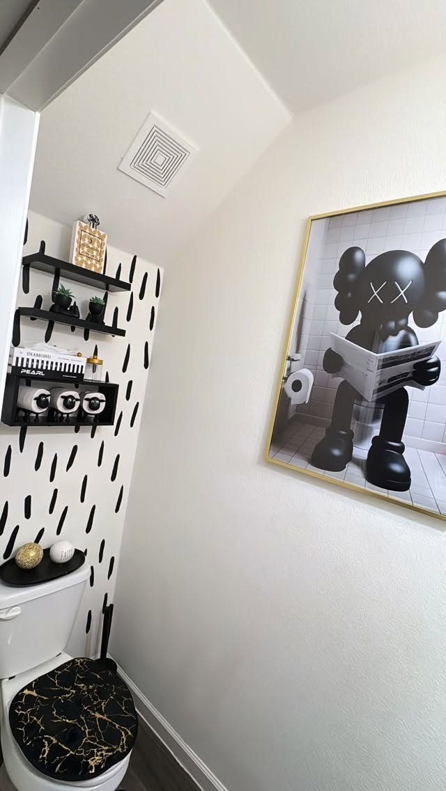 12 Half Bath Accent Wall Ideas That Work in Tight Spaces 13 A small bathroom with a black and white patterned accent wall and a toilet.