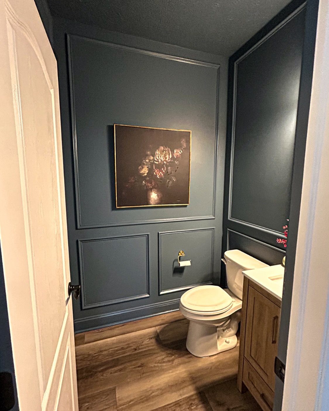 12 Half Bath Accent Wall Ideas That Work in Tight Spaces 7 Dark teal paneled walls and a matching dark ceiling in a small bathroom.