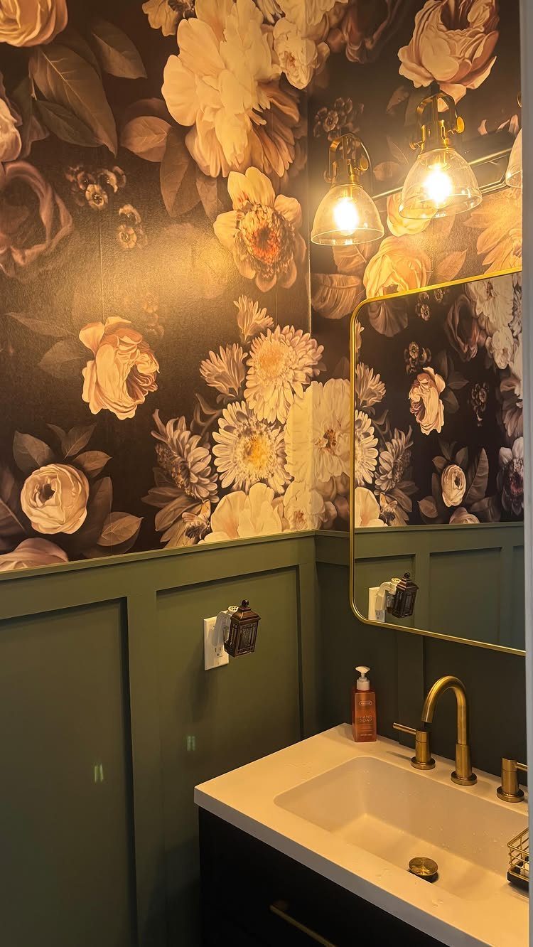 12 Half Bath Accent Wall Ideas That Work in Tight Spaces 2 Floral wallpaper accent wall above green wainscoting in a bathroom with gold fixtures.