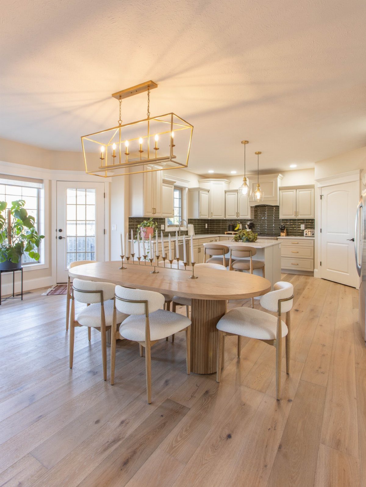 Light wood plank flooring in a bright, modern kitchen and dining room setting.
