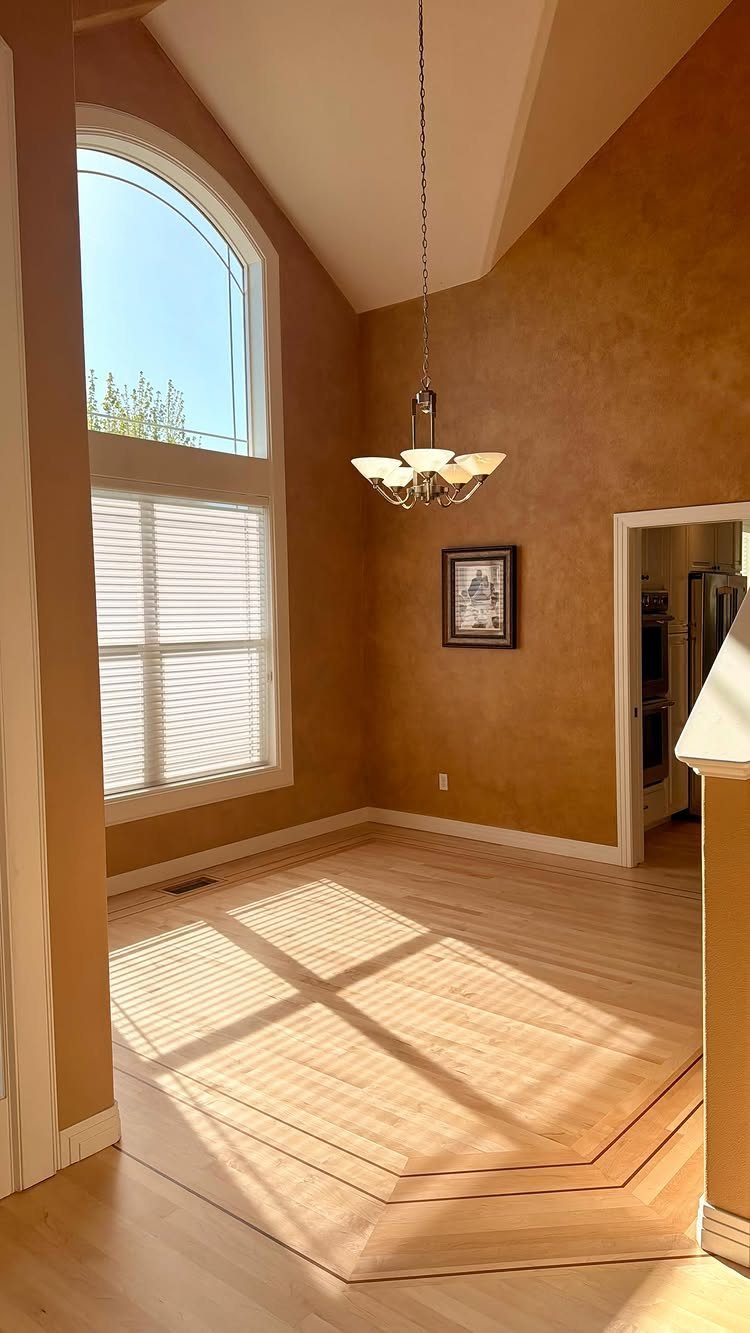 Light Wood Flooring: 10 Ideas That Actually Work 8 Light wood flooring with a decorative border in a sunlit room with ochre walls.