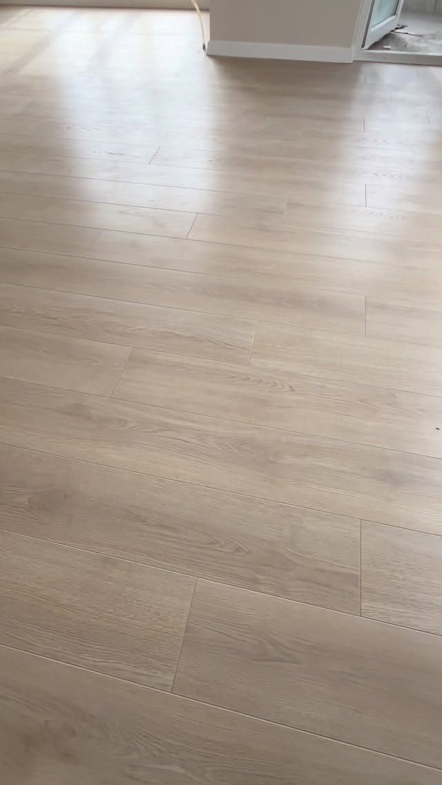 Light Wood Flooring: 10 Ideas That Actually Work 11 Light wood flooring planks with a natural grain pattern in a bright room.