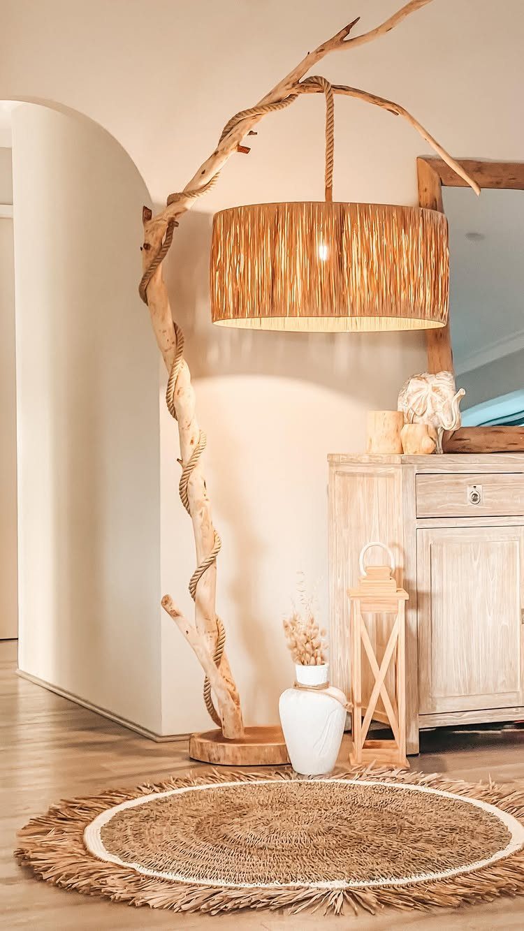 Light Wood Flooring: 10 Ideas That Actually Work 5 A round jute rug with fringe sits on light wood flooring near a driftwood lamp.