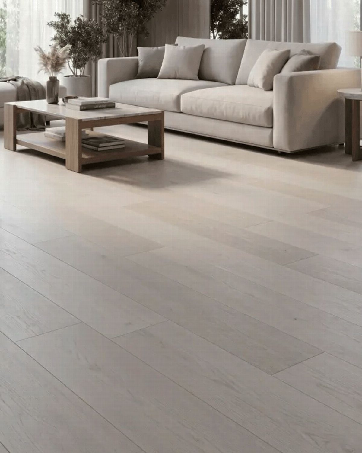 Light Wood Flooring: 10 Ideas That Actually Work 3 Light-colored wide plank wood flooring in a bright, modern living room with a beige sofa.