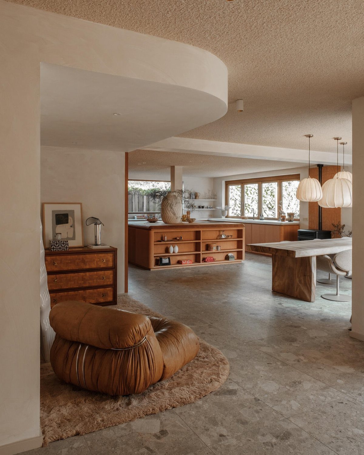 Light gray terrazzo tile flooring in a modern, open-concept living and dining room area.