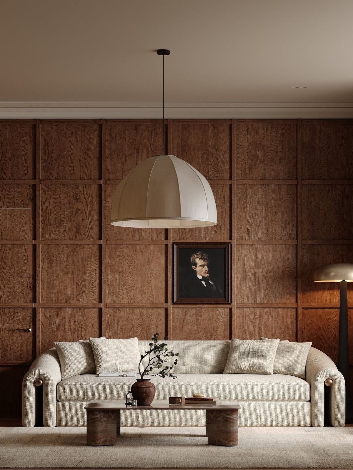 Dark wood grid wall paneling behind a cream sofa and a large dome pendant light.