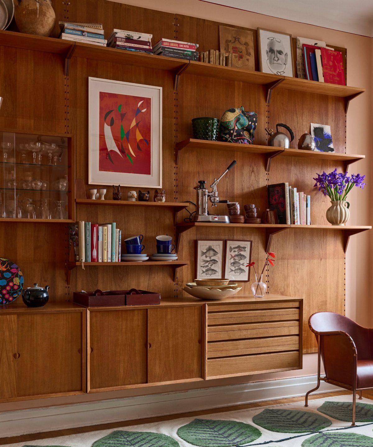 Mid-century modern wood wall paneling with integrated floating shelves and a built-in sideboard cabinet.