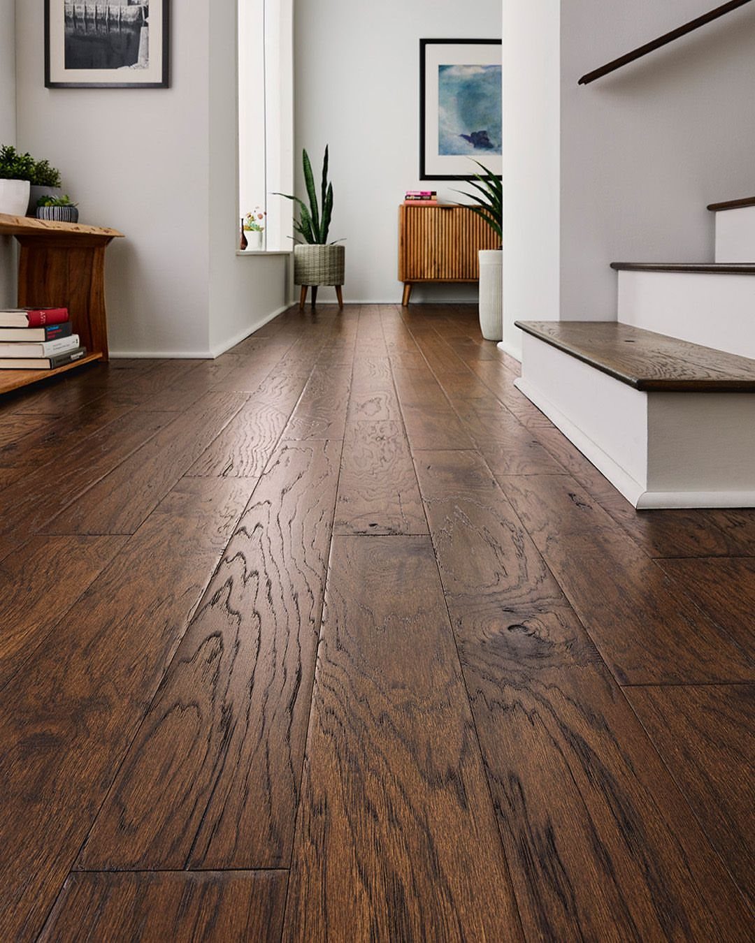 Dark brown hardwood floor planks with visible grain texture in a bright modern room.