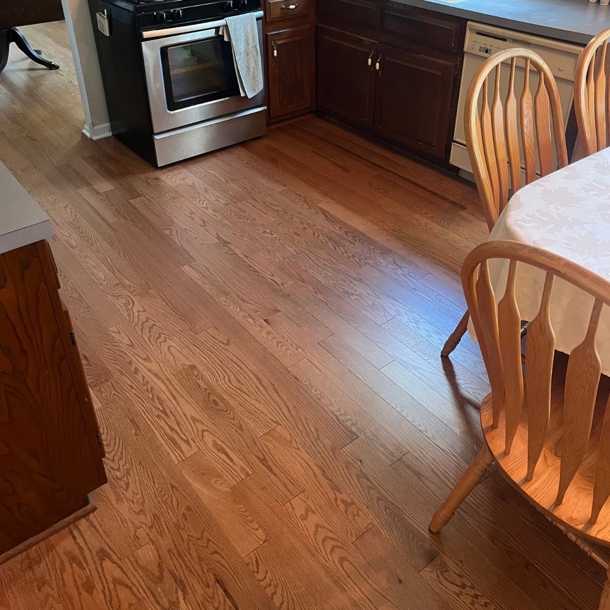 Wooden Flooring Design: 9 Ideas for Every Room 4 Light brown hardwood flooring with natural grain patterns in a kitchen and dining room setting.