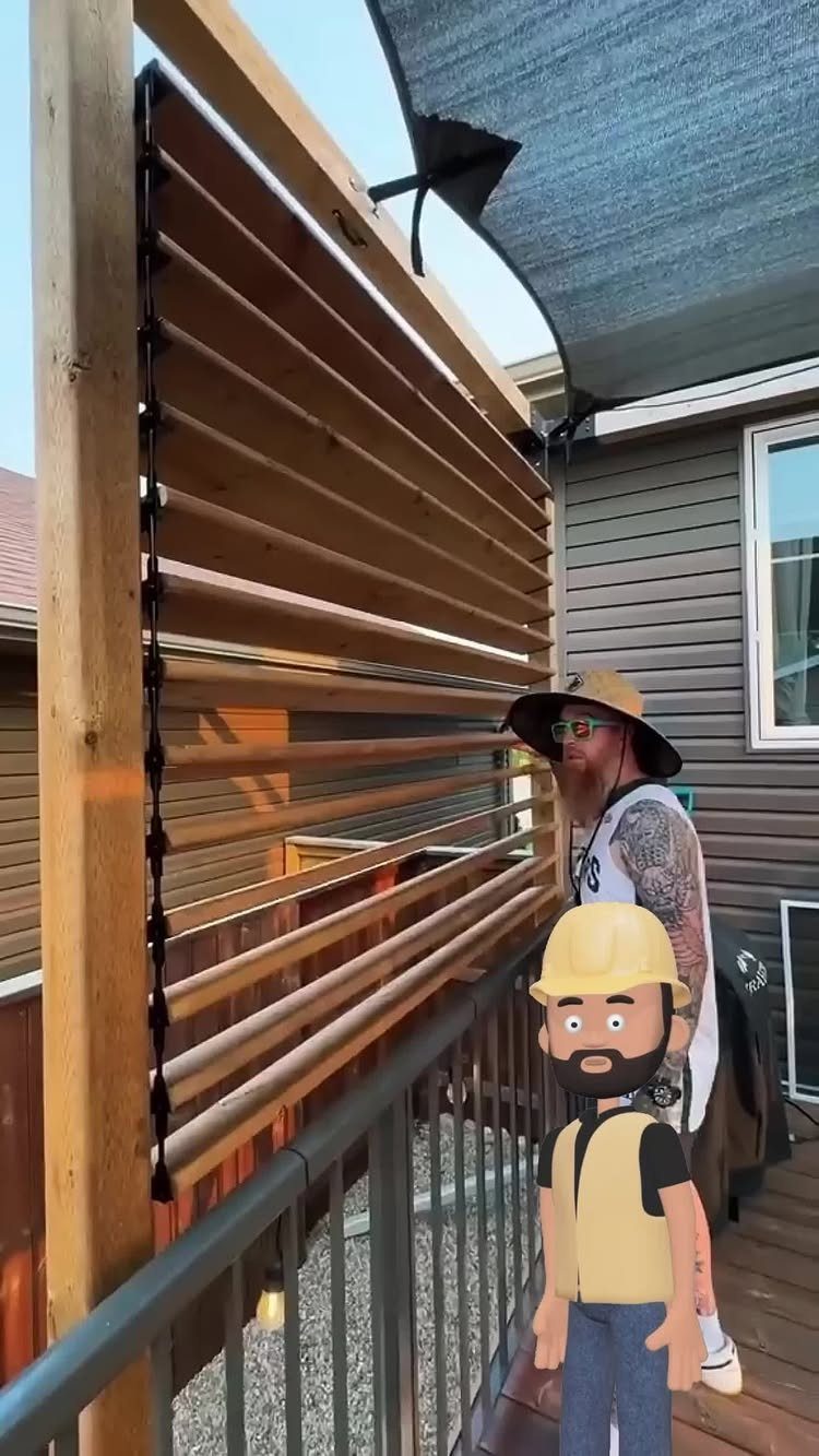 Wooden Privacy Fence: 12 Ideas That Define Your Yard 13 A man standing behind a modern horizontal wooden slat privacy screen on a deck.